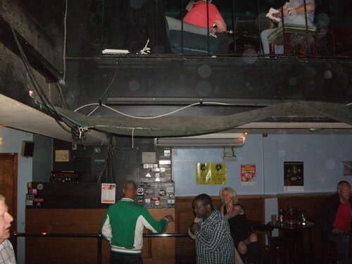 chris & keith holding onto the bar looking on jan